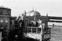 an old black and white photo of a boat docked in the water