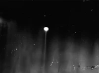 a black and white photo of an object in the sky