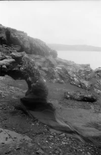 a black and white photo of a rock formation