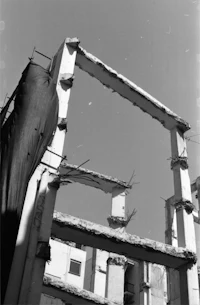 an old black and white photo of a building being demolished