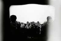 a black and white photograph of people in front of a building