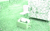 a man is sitting on a bench with a box in front of him