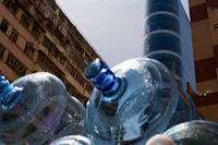 a group of water bottles in front of a building
