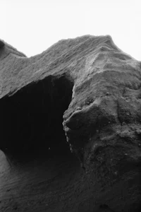 a black and white photo of a rock formation
