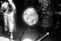 a group of women standing in front of a mirror